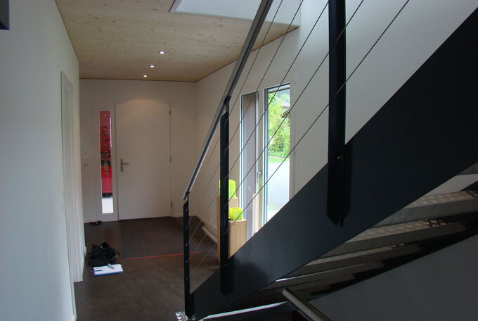 Treppenhaus in EFH, dunkles Stahlgeländer mit Chromstahlhandlauf, Aluminiumtritte